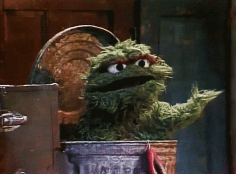 Gif of Oscar the Grouch in garbage can shaking his head