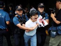 A student is detained while attempting to break into the Japanese embassy on the occasion of Japan releasing treated radioactive water from the wrecked Fukushima nuclear power plant into the Pacific Ocean, in Seoul, South Korea, August 24, 2023.