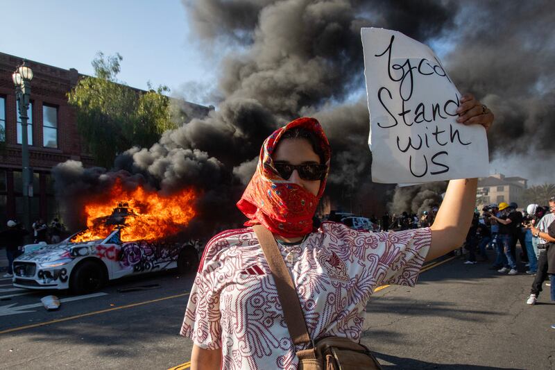 Crowds have torched cars and scuffled with law enforcement amid the unrest.