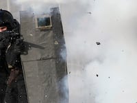Members of the Spetsnaz storm a building during a performance for spectators in Krasnoyarsk, Russia, Feb. 21, 2012.