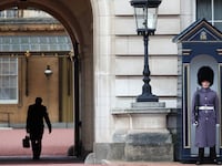A guard stands outside Buckingham Palace.
