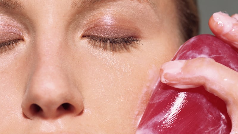 A woman cleansing her skin