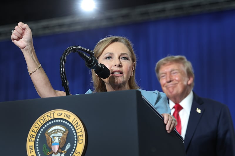 U.S. President Donald Trump listens to U.S. Sen. Darline Graham (R-SC) during a campaign rally on August 21, 2026, in Myrtle Beach, South Carolina.