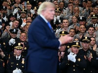 Law enforcement members applaud US President Donald Trump as he departs after delivering remarks at the Nassau County Police Academy Center for Training and Intelligence in Garden City, New York, on August 14, 2026.