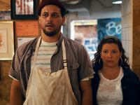 A photo including Justina Machado (Dolores Roach), Alejandro Hernandez (Luis) in The Horror of Dolores Roach in the show.