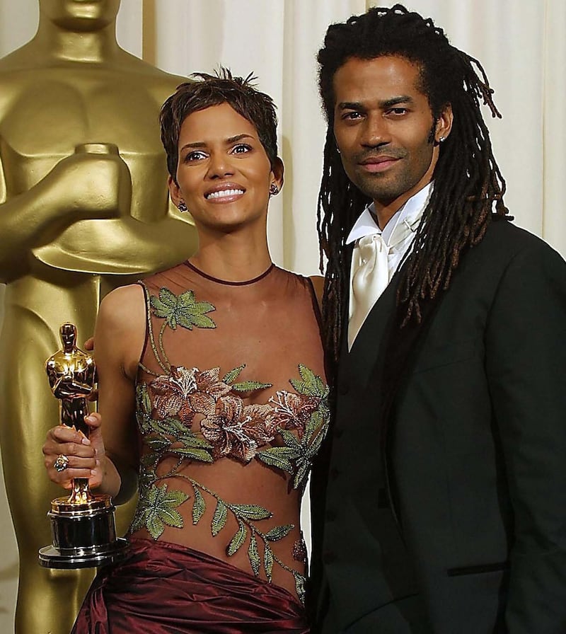 Halle Berry and her then-husband Eric Benet as Berry holds the Oscar for Best Actress on March 24, 2002.