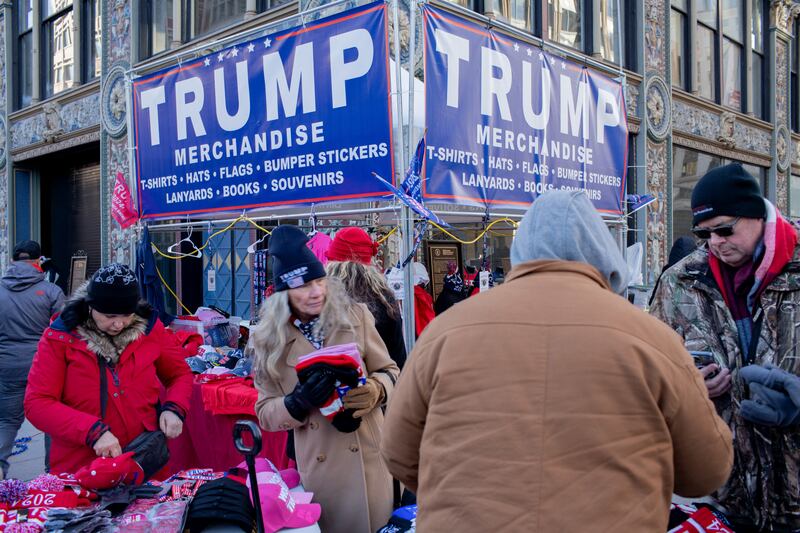A merchandise booth displaying Trump-themed items, including hats, T-shirts, and souvenirs, on January 20, 2025, in Washington, D.C., during President Donald J. Trump's second inauguration ceremony. (Photo by Kia Rastar / Middle East Images / Middle East Images via AFP) (Photo by KIA RASTAR/Middle East Images/AFP via Getty Images)