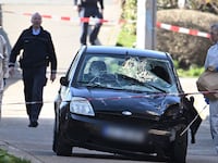 Forensics officers examine a damaged vehicle on an access road to the Rhine bridge in the German city of Mannheim on March 3, 2025.