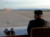 North Korean leader Kim Jong Un watches the launch of a Hwasong-12 missile.