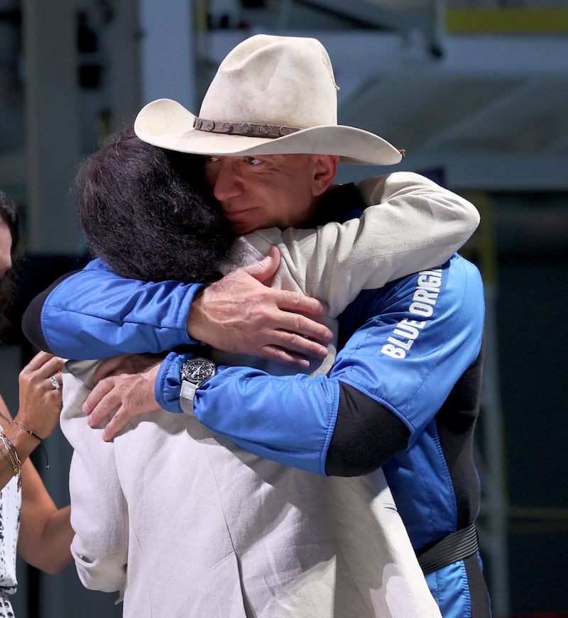 VAN HORN, TEXAS - JULY 20: Jeff Bezos hugs his mother, Jacklyn Bezos, after his flight on Blue Origin’s New Shepard into space during a press conference on July 20, 2021 in Van Horn, Texas. Mr. Bezos and the crew that flew with him were the first human spaceflight for the company. (Photo by Joe Raedle/Getty Images)