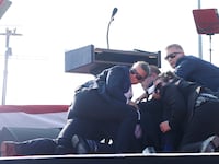 Republican presidential candidate former President Donald Trump is rushed offstage during a rally on July 13, 2024 in Butler, Pennsylvania.