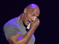 Dwayne Johnson tearing up on stage.