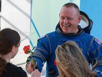 NASA’s Boeing Crew Flight Test Commander Butch Wilmore greets people as he walks out of the Operations and Checkout Building on June 01, 2024 in Cape Canaveral, Florida.