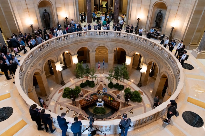 People look on as Rep. Melissa Hortman, her husband Mark Hortman, and their dog Gilbert lie in state in the rotunda of the Capitol building on June 27 in St. Paul, Minnesota.